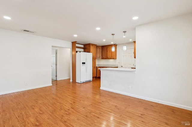 unfurnished living room featuring baseboards, recessed lighting, light wood-style flooring, and visible vents