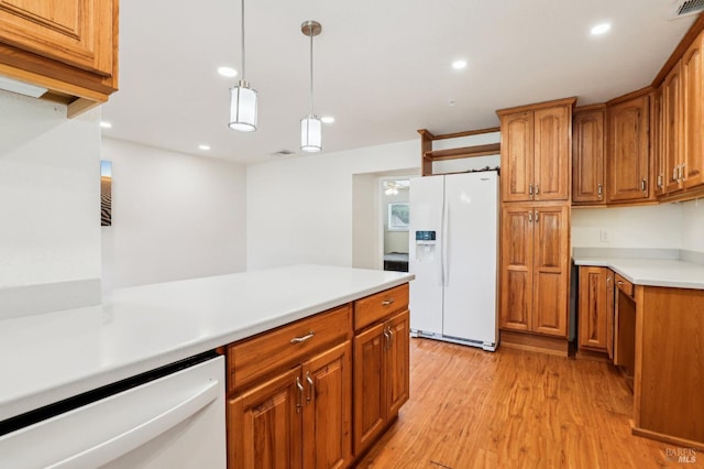 kitchen featuring brown cabinetry, light countertops, light wood-style floors, recessed lighting, and white appliances