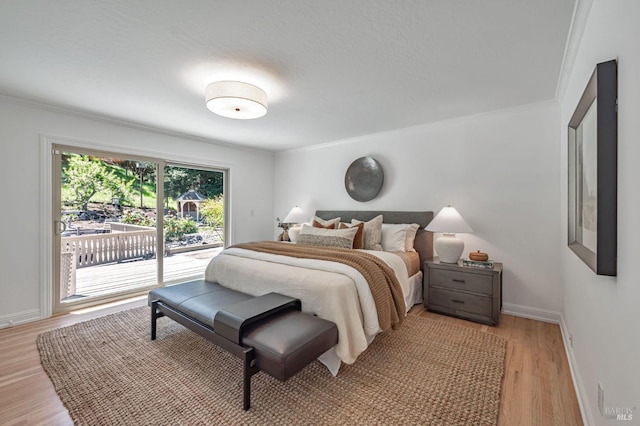 bedroom with light wood-style floors, baseboards, access to outside, and ornamental molding