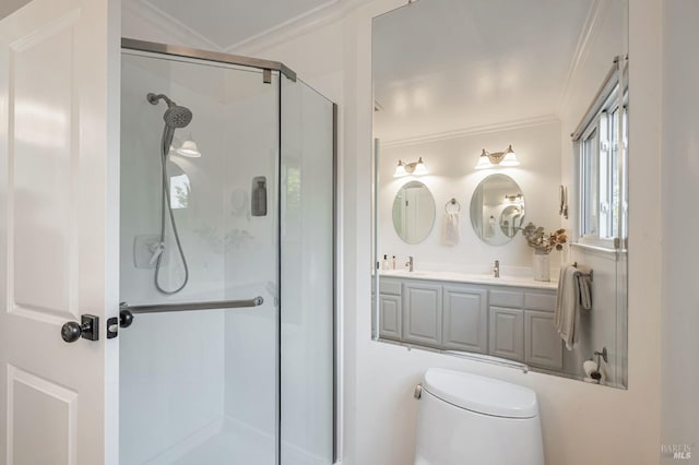 bathroom featuring double vanity, ornamental molding, toilet, a sink, and a stall shower