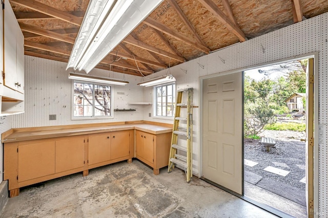 kitchen with open shelves and concrete floors