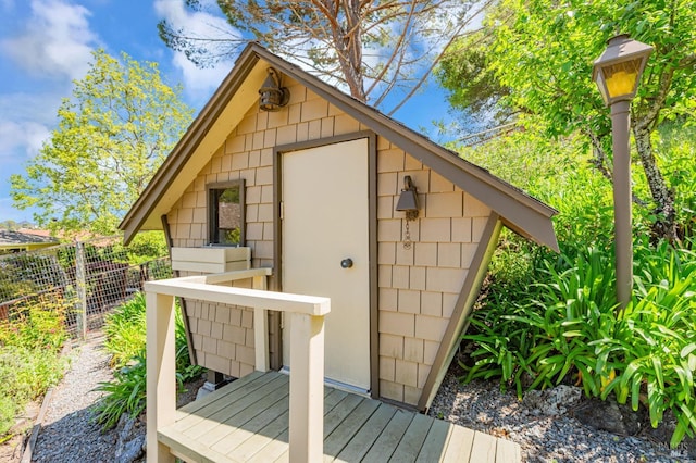 view of outbuilding with fence