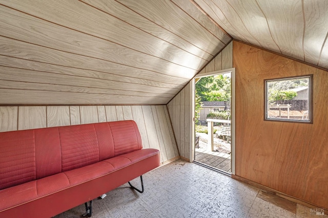 additional living space with wood walls, vaulted ceiling, and wooden ceiling