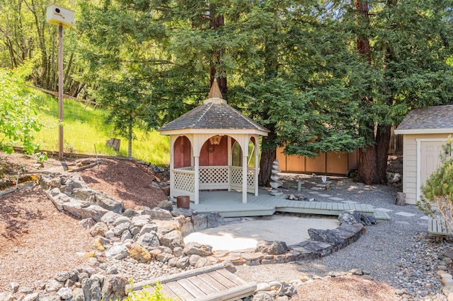 view of yard featuring a deck and a gazebo