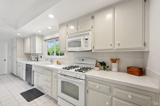 kitchen with white appliances, recessed lighting, tile countertops, backsplash, and light tile patterned floors