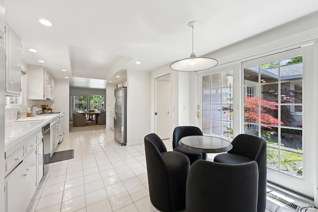dining area with recessed lighting, light tile patterned floors, and a baseboard radiator