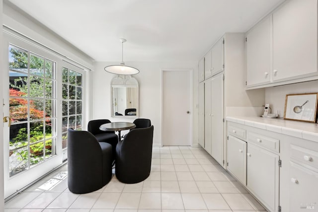dining room featuring light tile patterned flooring and a wealth of natural light