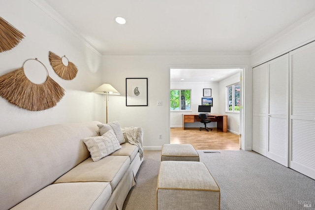 carpeted living area featuring crown molding, recessed lighting, and baseboards