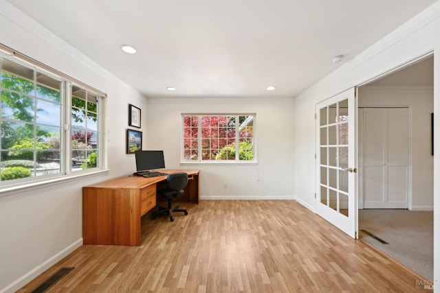 office featuring crown molding, visible vents, baseboards, french doors, and light wood-style flooring