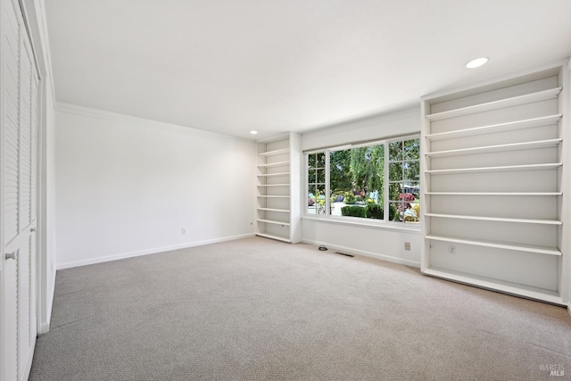 spare room featuring visible vents, ornamental molding, baseboards, recessed lighting, and carpet flooring