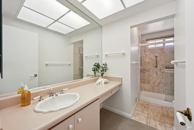 full bathroom featuring baseboards, marble finish floor, a stall shower, and vanity