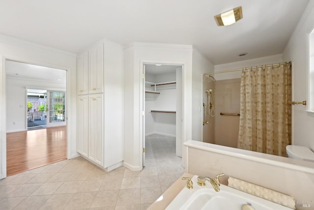 bathroom with a bath, crown molding, curtained shower, and tile patterned flooring