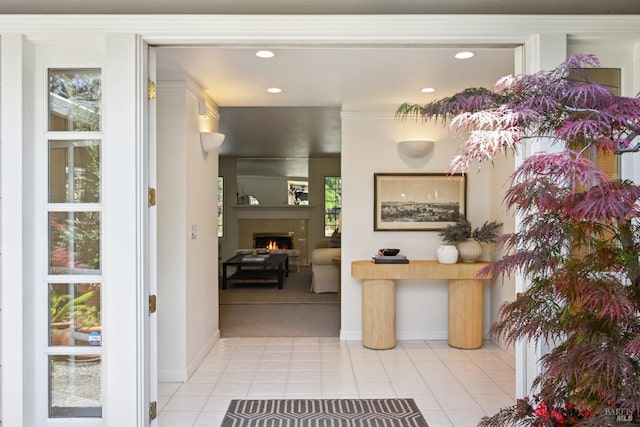 hallway featuring light tile patterned floors, baseboards, and recessed lighting