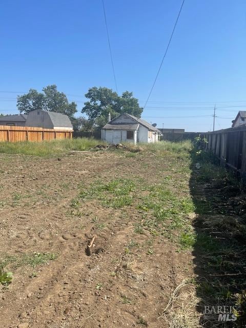 view of yard featuring fence and an outdoor structure