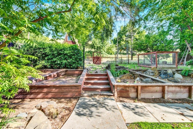 view of yard featuring fence and a garden