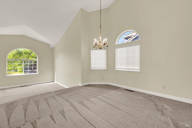 carpeted spare room featuring visible vents, a wealth of natural light, a chandelier, and lofted ceiling