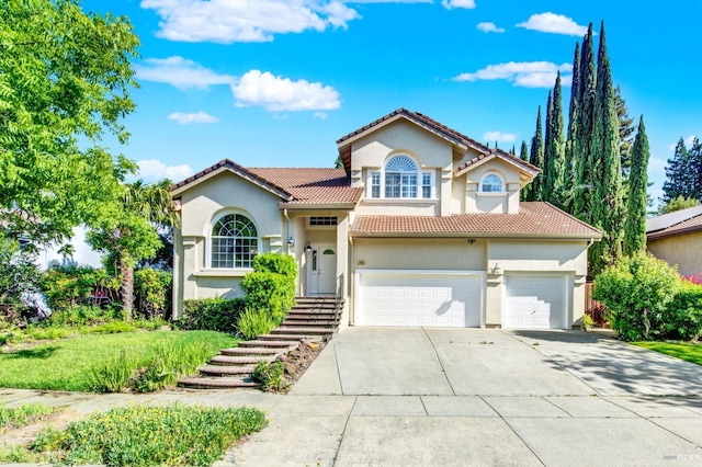 view of front of house with a garage, stucco siding, concrete driveway, and a tile roof