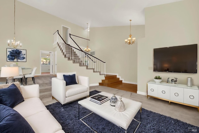 living area featuring stairs, a notable chandelier, and a towering ceiling