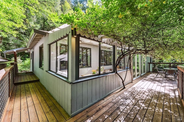 wooden deck featuring outdoor dining area