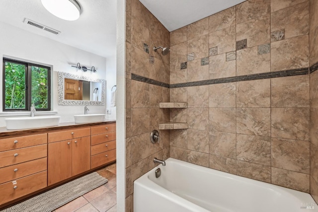 full bathroom featuring shower / washtub combination, vanity, tile patterned floors, and visible vents