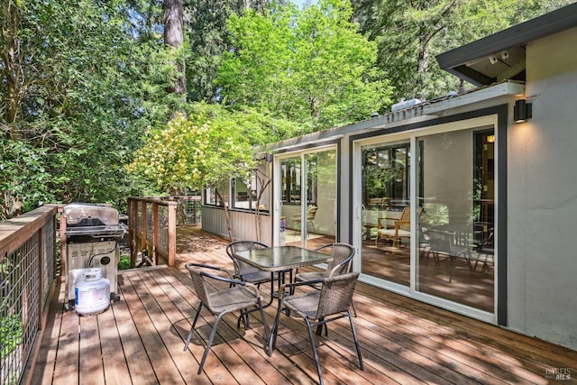 wooden deck featuring outdoor dining area