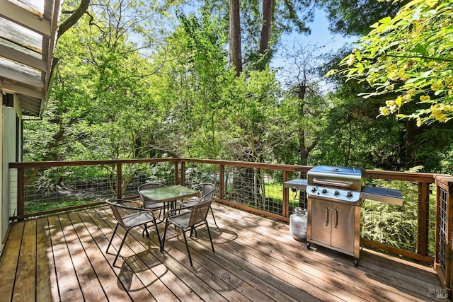 wooden deck featuring outdoor dining space