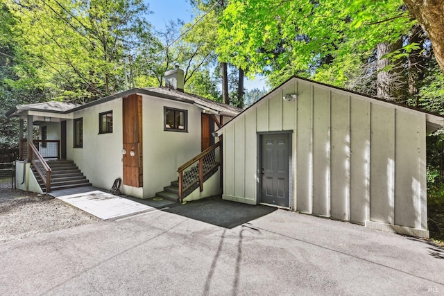 view of outdoor structure with an outbuilding and stairs