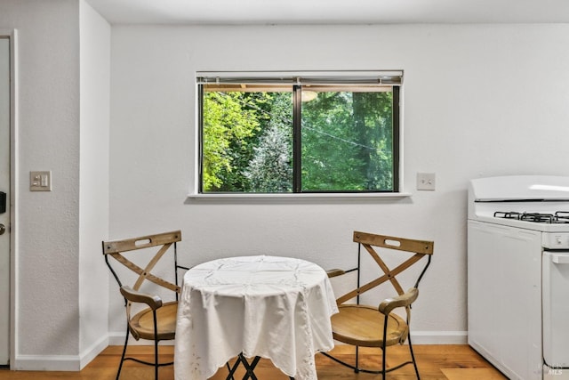 dining area featuring baseboards and light wood-type flooring