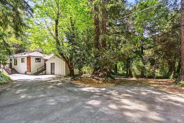 exterior space featuring entry steps and aphalt driveway