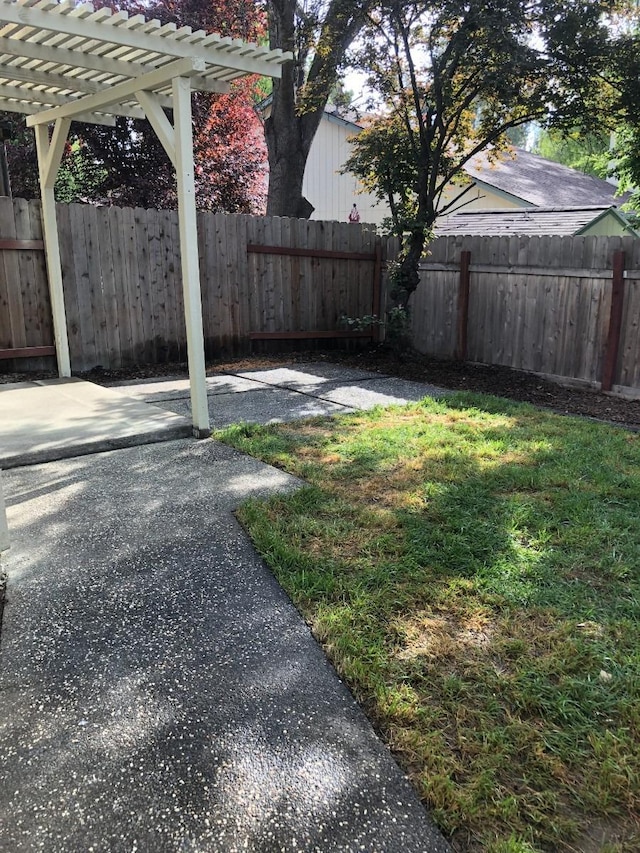 view of yard with a patio, fence, and a pergola