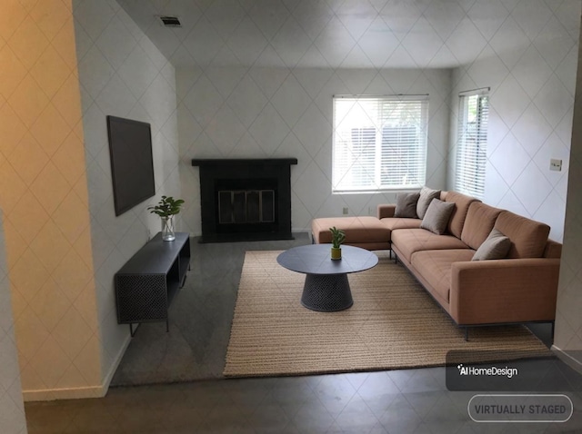 living room with a fireplace with flush hearth and visible vents
