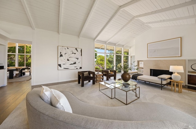 living area with wood-type flooring, beamed ceiling, and plenty of natural light