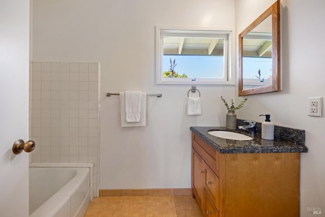 bathroom featuring a shower, vanity, tile patterned flooring, a bathing tub, and baseboards