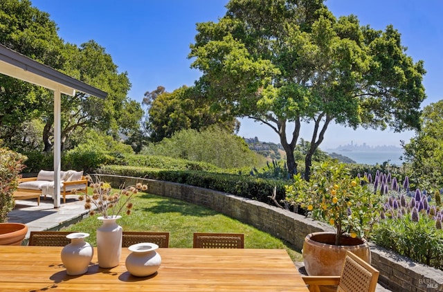 deck featuring a lawn, outdoor dining area, and a fenced backyard