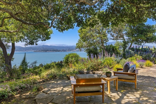 view of patio featuring a water and mountain view