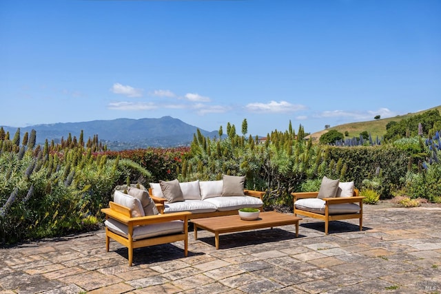 view of patio featuring an outdoor hangout area and a mountain view