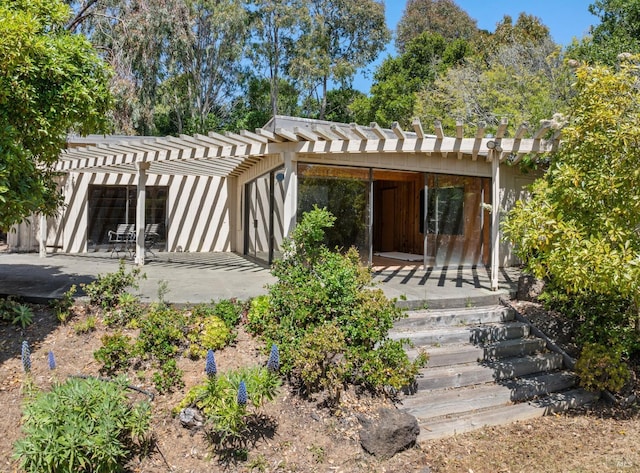 back of house with a pergola and a patio area