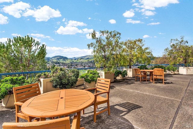 view of patio featuring a mountain view and outdoor dining area