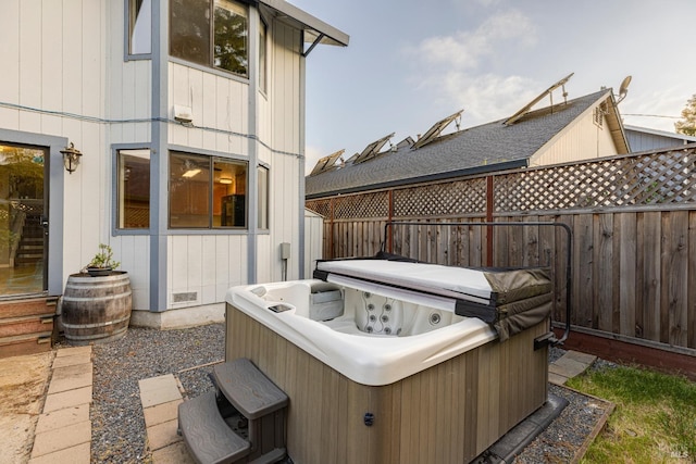view of patio / terrace with fence and a hot tub