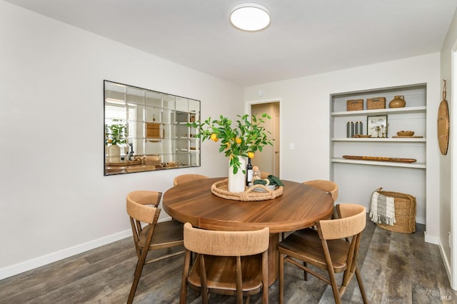 dining space featuring baseboards and wood finished floors