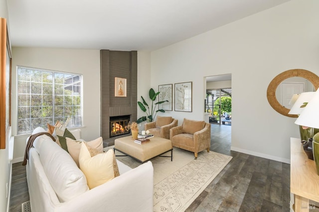 living area with baseboards, dark wood finished floors, and a fireplace