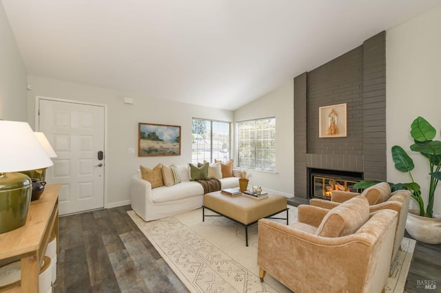 living room featuring baseboards, a fireplace, vaulted ceiling, and dark wood finished floors