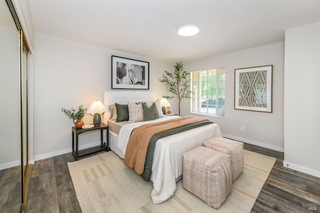 bedroom featuring baseboards, a closet, and wood finished floors