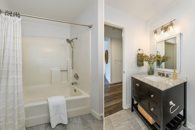 bathroom with vanity, baseboards, and shower / tub combo