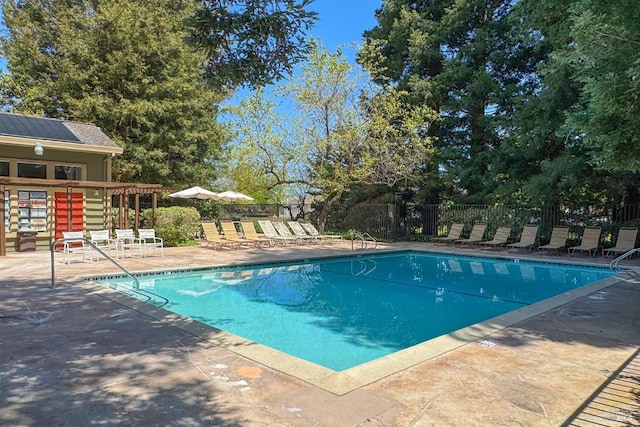 pool featuring a patio and fence