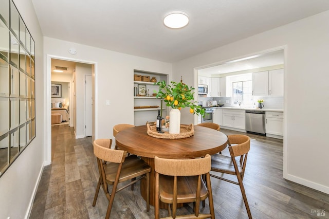 dining room with baseboards, dark wood finished floors, and visible vents
