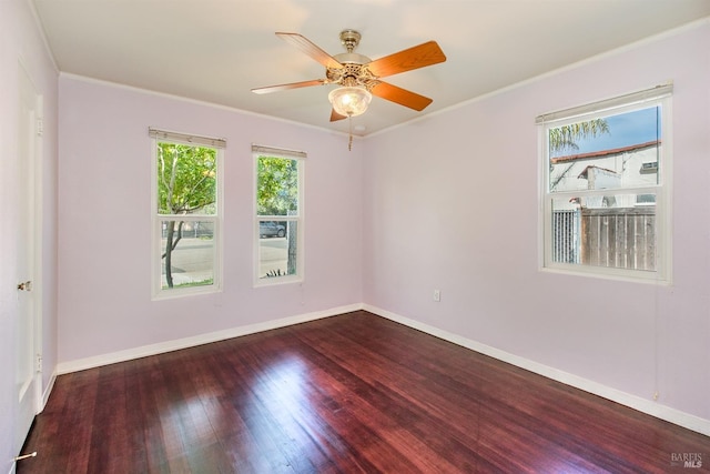 empty room with crown molding, baseboards, ceiling fan, and wood finished floors