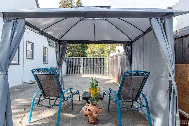 view of patio with a gazebo and fence