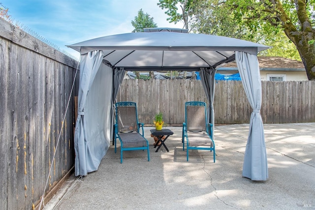 view of patio / terrace with a fenced backyard and a gazebo