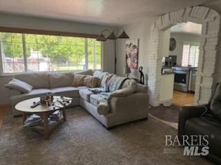 living room with arched walkways